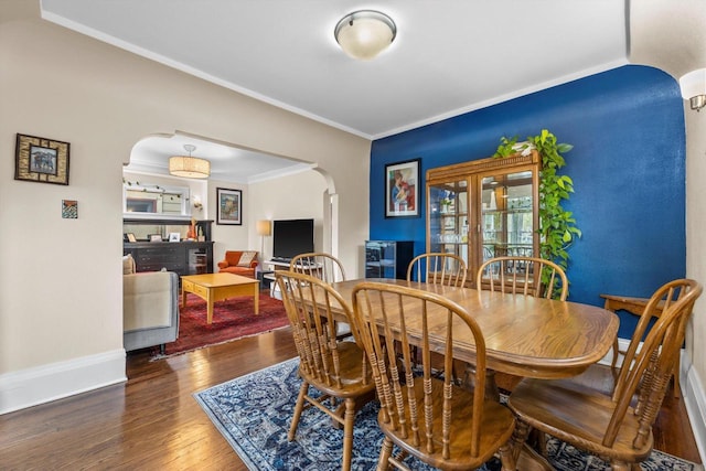 3715 N 2nd St, Milwaukee, WI 53212 - dining space featuring arched walkways, wood finished floors, and crown molding