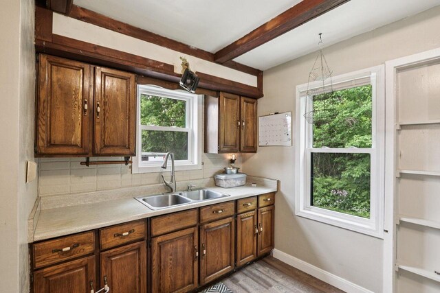 3352 S Adams Ave, Milwaukee, WI 53207 - kitchen featuring light countertops, plenty of natural light, decorative backsplash, and beamed ceiling
