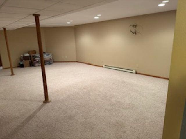 1064 Sunny Ridge Cir, Nekoosa, WI 54457 - finished basement with a baseboard heating unit, carpet flooring, and recessed lighting