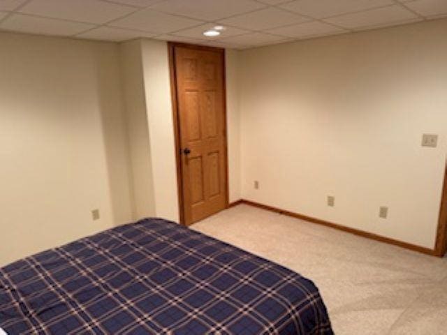 1064 Sunny Ridge Cir, Nekoosa, WI 54457 - unfurnished bedroom featuring carpet floors and a paneled ceiling
