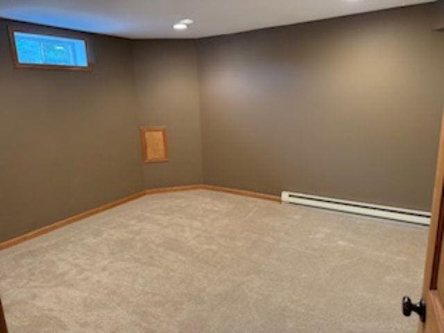 1064 Sunny Ridge Cir, Nekoosa, WI 54457 - finished basement with baseboard heating, carpet flooring, and recessed lighting