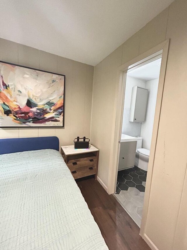 5869 Country Club Rd, Houston, MN 55943 - bedroom featuring dark wood-style floors and connected bathroom