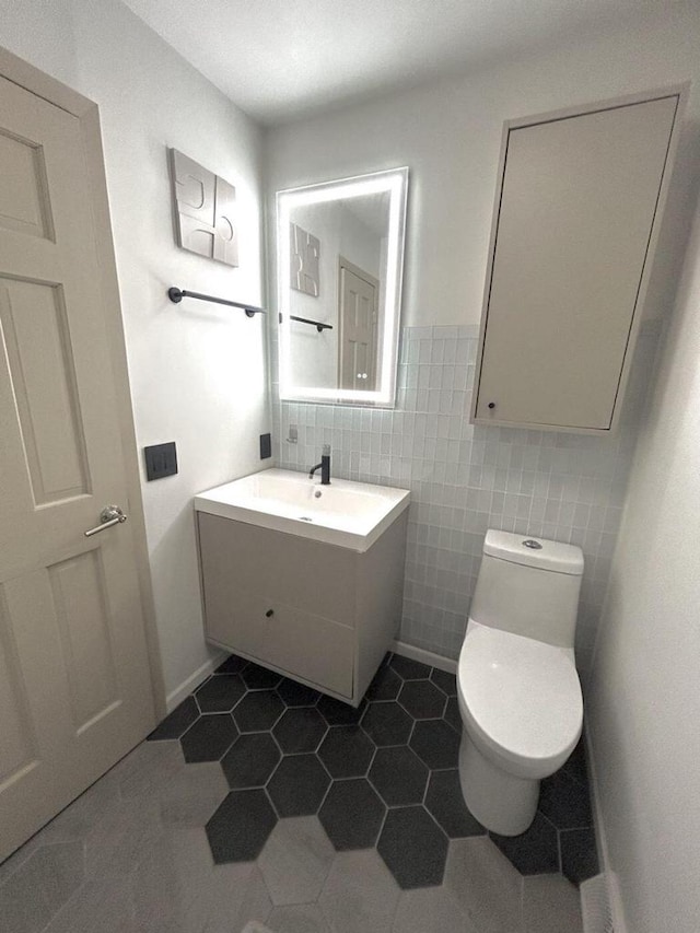 5869 Country Club Rd, Houston, MN 55943 - bathroom featuring vanity, tile patterned flooring, tile walls, and wainscoting