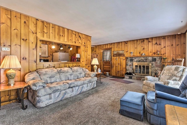 1119 Gross Rd, Woodruff, WI 54568 - carpeted living room featuring wood walls and a fireplace