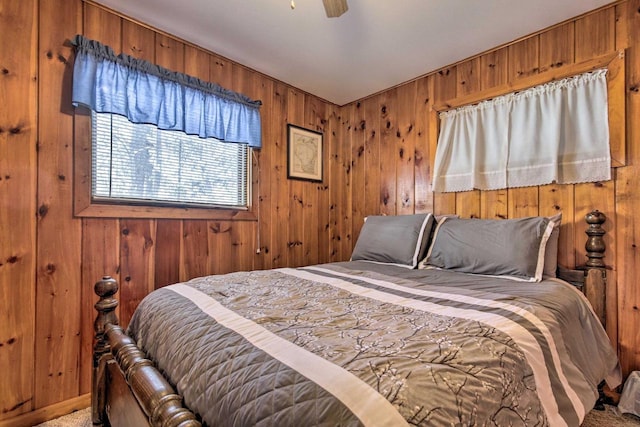 1119 Gross Rd, Woodruff, WI 54568 - bedroom with wooden walls, ceiling fan, and light carpet