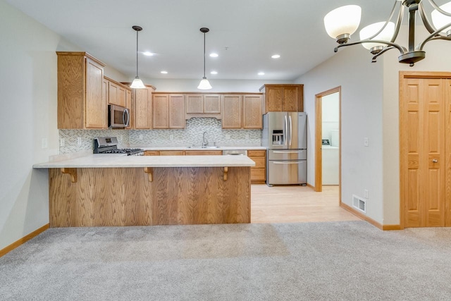 7942 Williamsburg Ct Unit 101, Bristol, WI 53104 - kitchen featuring appliances with stainless steel finishes, light carpet, light countertops, a peninsula, and recessed lighting