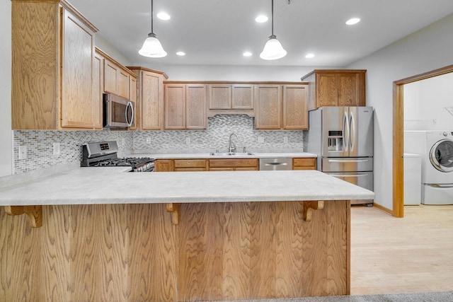 7942 Williamsburg Ct Unit 101, Bristol, WI 53104 - kitchen featuring stainless steel appliances, a peninsula, light countertops, a kitchen breakfast bar, and recessed lighting