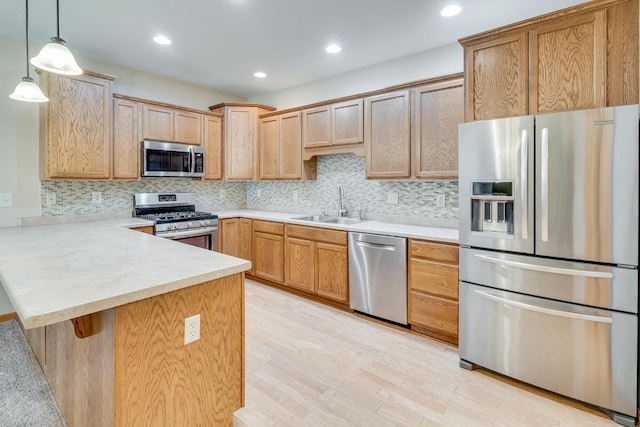 7942 Williamsburg Ct Unit 101, Bristol, WI 53104 - kitchen featuring stainless steel appliances, a peninsula, light countertops, tasteful backsplash, and recessed lighting
