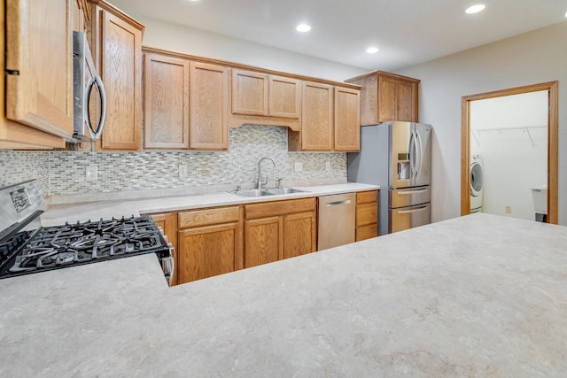 7942 Williamsburg Ct Unit 101, Bristol, WI 53104 - kitchen with stainless steel appliances, washer / dryer, light countertops, tasteful backsplash, and recessed lighting