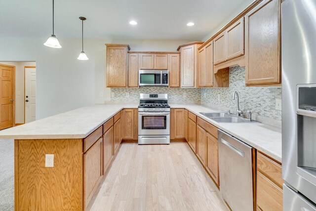 7942 Williamsburg Ct Unit 101, Bristol, WI 53104 - kitchen with stainless steel appliances, a peninsula, light wood-style floors, decorative backsplash, and recessed lighting