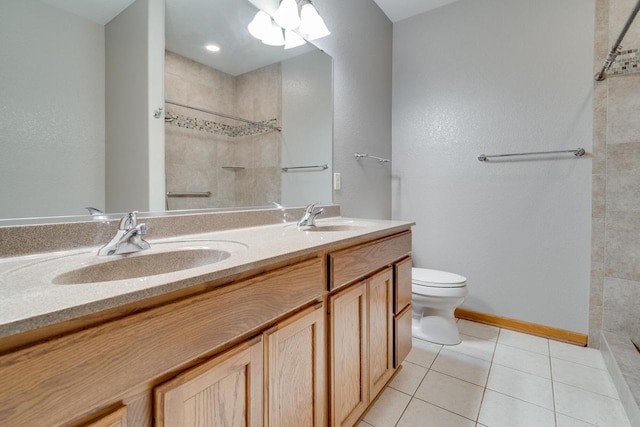 7942 Williamsburg Ct Unit 101, Bristol, WI 53104 - bathroom with double vanity, tiled shower, and tile patterned floors