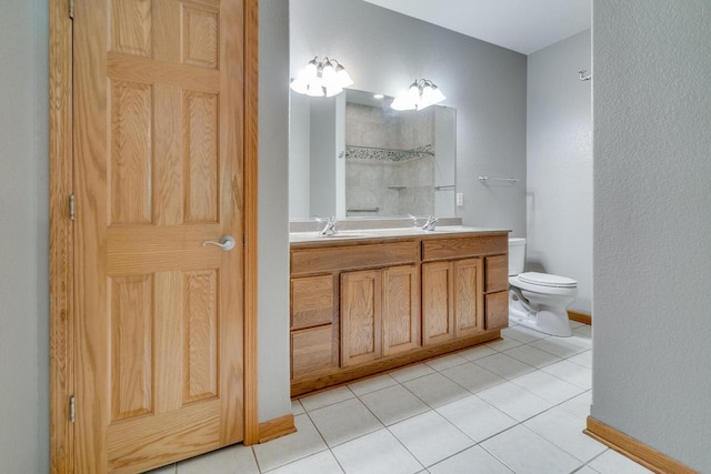 7942 Williamsburg Ct Unit 101, Bristol, WI 53104 - bathroom featuring double vanity, a shower, and tile patterned flooring