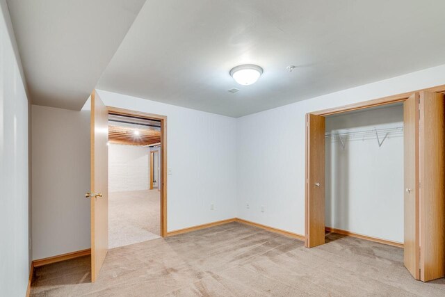 7942 Williamsburg Ct Unit 101, Bristol, WI 53104 - unfurnished bedroom with light carpet and a closet