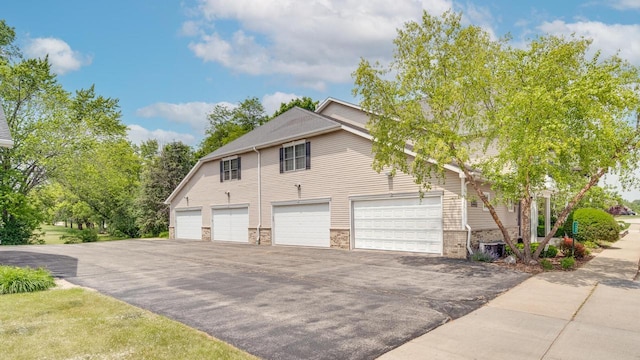 7942 Williamsburg Ct Unit 101, Bristol, WI 53104 - view of home's exterior with asphalt driveway and an attached garage