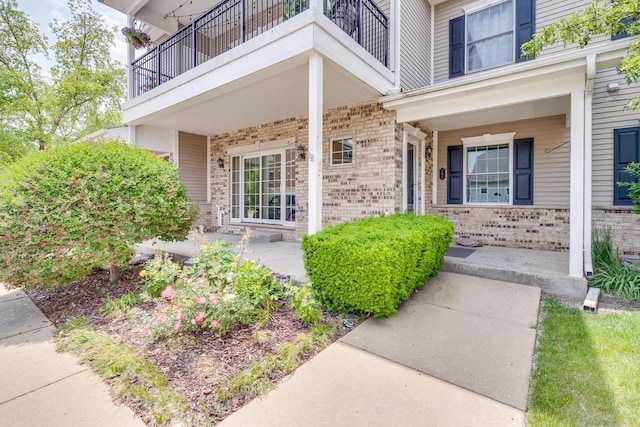 7942 Williamsburg Ct Unit 101, Bristol, WI 53104 - property entrance featuring brick siding, a porch, and a balcony