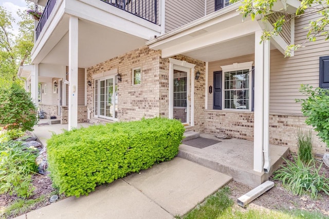 7942 Williamsburg Ct Unit 101, Bristol, WI 53104 - entrance to property featuring covered porch, brick siding, and a balcony