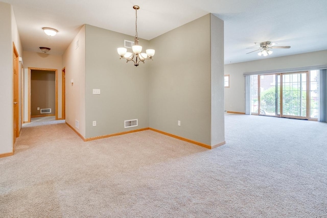 7942 Williamsburg Ct Unit 101, Bristol, WI 53104 - spare room featuring light colored carpet, a chandelier, and a ceiling fan