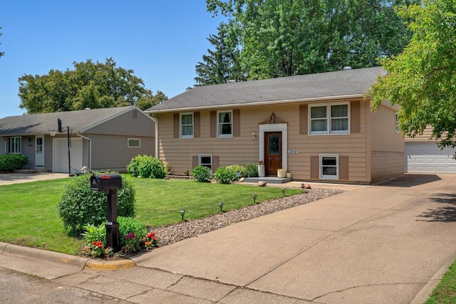 3202 34th St, South Street, La Crosse, WI 54601 - view of front facade with a front lawn, concrete driveway, and a garage