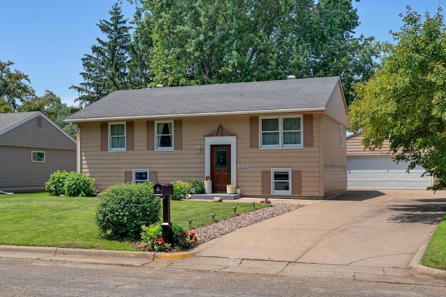 3202 34th St, South Street, La Crosse, WI 54601 - bi-level home featuring a front yard, a garage, and an outdoor structure