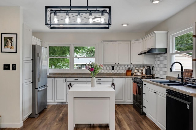 3202 34th St, South Street, La Crosse, WI 54601 - kitchen featuring black appliances, under cabinet range hood, white cabinets, a center island, and dark wood finished floors