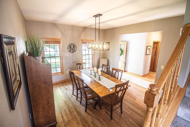 120 Wind Sail Ct, Random Lake, WI 53075 - dining room with stairs, wood finished floors, and a chandelier