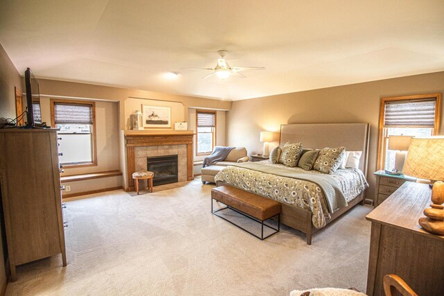 120 Wind Sail Ct, Random Lake, WI 53075 - bedroom featuring light colored carpet, a tiled fireplace, and a ceiling fan