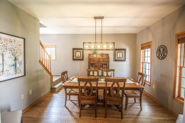 120 Wind Sail Ct, Random Lake, WI 53075 - dining space featuring plenty of natural light, dark wood-style floors, and stairway