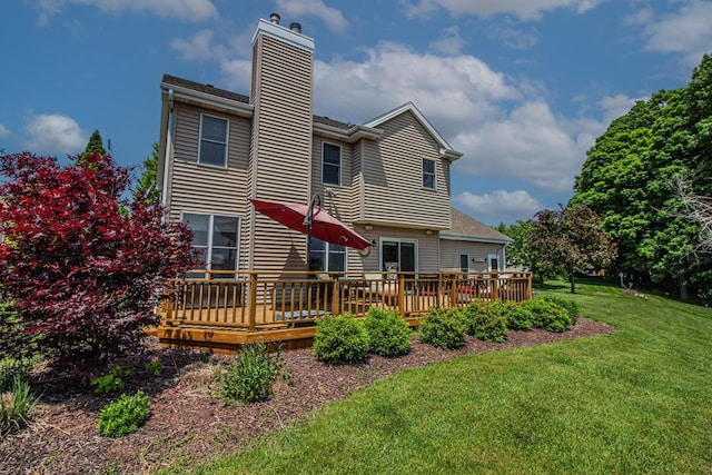 120 Wind Sail Ct, Random Lake, WI 53075 - back of property with a chimney, a yard, and a deck