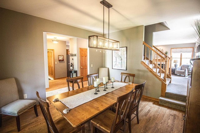 120 Wind Sail Ct, Random Lake, WI 53075 - dining space with wood finished floors and stairs