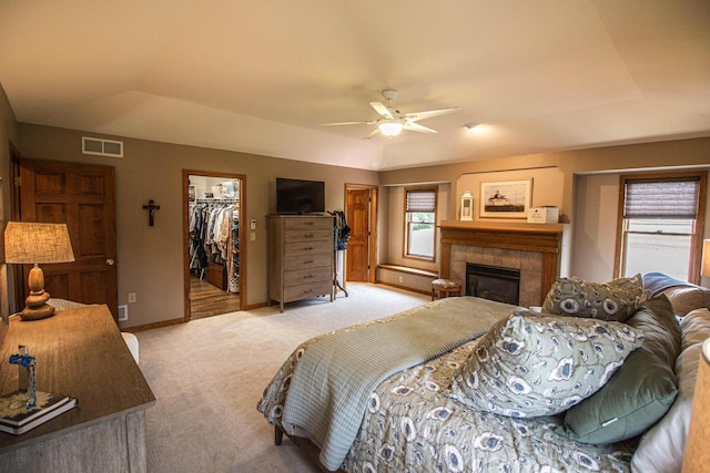 120 Wind Sail Ct, Random Lake, WI 53075 - carpeted bedroom with a fireplace, a spacious closet, a ceiling fan, and a closet