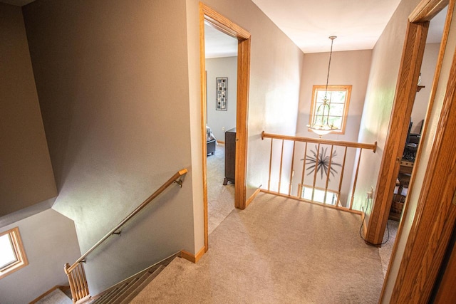 120 Wind Sail Ct, Random Lake, WI 53075 - hall featuring an upstairs landing, carpet floors, and a chandelier