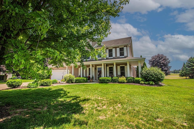 120 Wind Sail Ct, Random Lake, WI 53075 - colonial inspired home featuring a porch, a front yard, an attached garage, and driveway