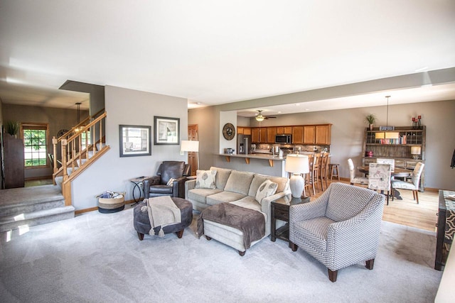 120 Wind Sail Ct, Random Lake, WI 53075 - living area with stairway, light carpet, and a ceiling fan