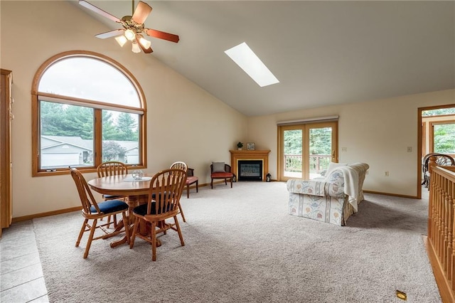 3413 Mcelroy Ct, Eau Claire, WI 54701 - dining area with a skylight, lofted ceiling, a glass covered fireplace, ceiling fan, and light carpet