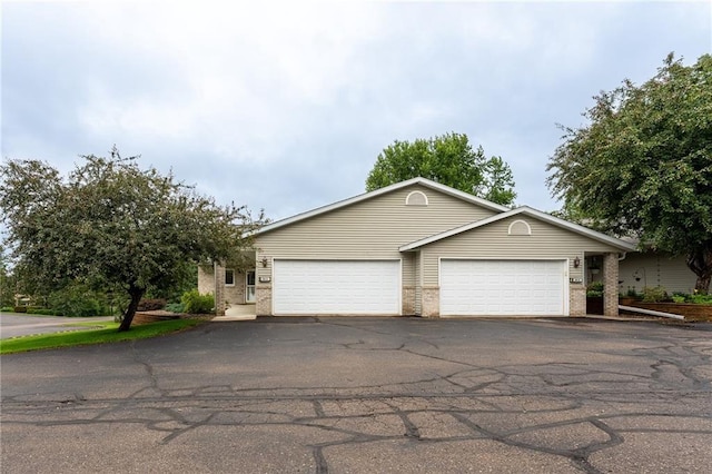 3413 Mcelroy Ct, Eau Claire, WI 54701 - view of front of property with driveway, brick siding, and a garage