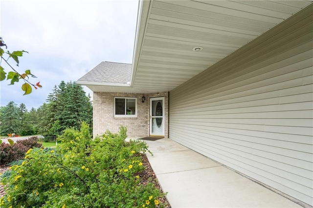 3413 Mcelroy Ct, Eau Claire, WI 54701 - entrance to property featuring brick siding and a shingled roof