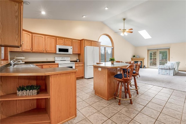 3413 Mcelroy Ct, Eau Claire, WI 54701 - kitchen featuring white appliances, a skylight, open floor plan, healthy amount of natural light, and high vaulted ceiling