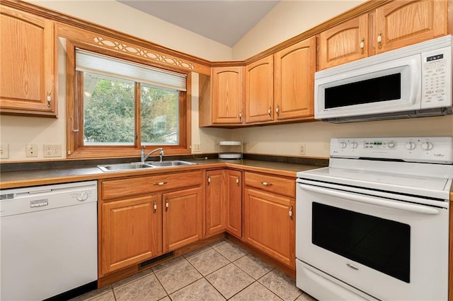 3413 Mcelroy Ct, Eau Claire, WI 54701 - kitchen featuring white appliances, vaulted ceiling, light tile patterned floors, and dark countertops