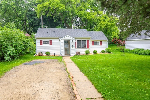 720 De Clark St, Beaver Dam, WI 53916 - view of front facade with a front yard and roof with shingles