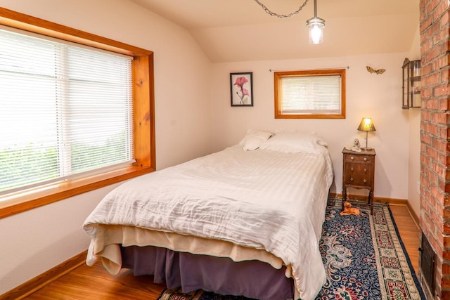 720 De Clark St, Beaver Dam, WI 53916 - bedroom featuring vaulted ceiling and wood finished floors