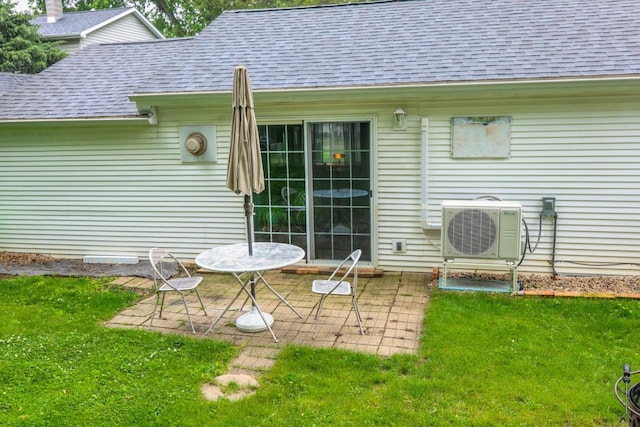 720 De Clark St, Beaver Dam, WI 53916 - back of house with a shingled roof, a patio area, and a yard