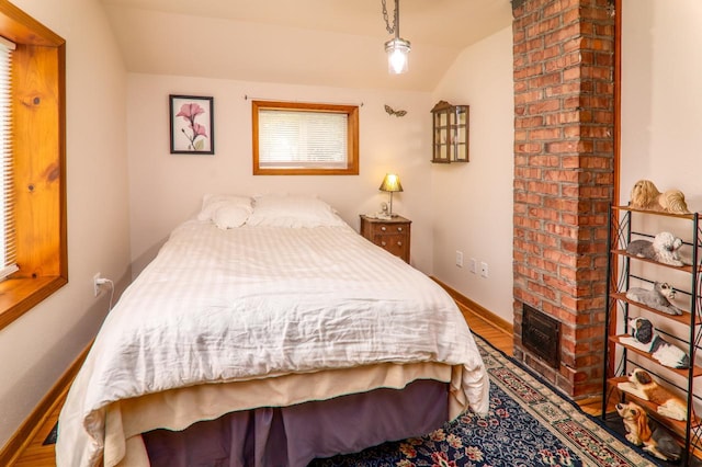 720 De Clark St, Beaver Dam, WI 53916 - bedroom featuring vaulted ceiling and wood finished floors