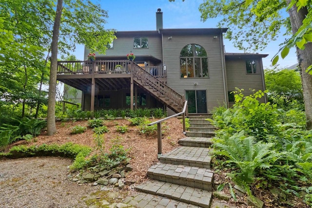 2510 Hillside Heights Dr, Green Bay, WI 54311 - rear view of house featuring stairway, a wooden deck, and a chimney