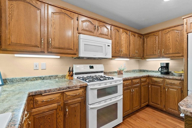 2510 Hillside Heights Dr, Green Bay, WI 54311 - kitchen featuring white appliances, brown cabinets, and light wood-type flooring