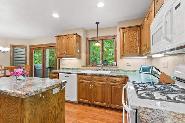 2510 Hillside Heights Dr, Green Bay, WI 54311 - kitchen with white appliances, plenty of natural light, pendant lighting, brown cabinetry, and recessed lighting