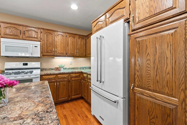 2510 Hillside Heights Dr, Green Bay, WI 54311 - kitchen with white appliances, brown cabinets, light wood finished floors, and recessed lighting
