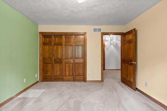 2510 Hillside Heights Dr, Green Bay, WI 54311 - unfurnished bedroom with carpet, a textured ceiling, and a closet