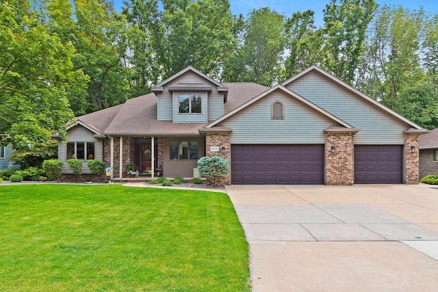 2510 Hillside Heights Dr, Green Bay, WI 54311 - view of front of home with an attached garage, a front lawn, driveway, and brick siding