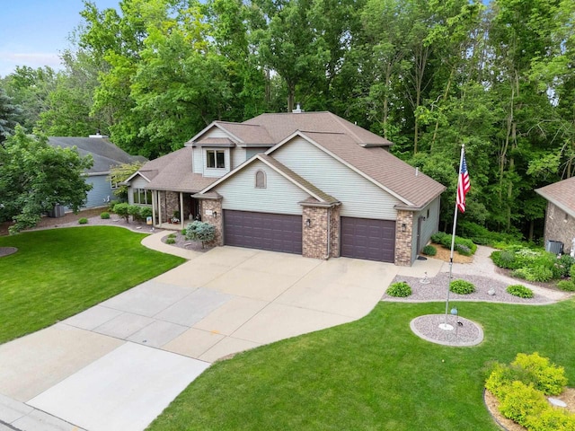 2510 Hillside Heights Dr, Green Bay, WI 54311 - view of front of house with concrete driveway, an attached garage, a front lawn, and a shingled roof