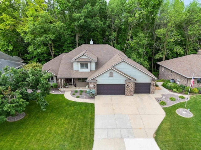 2510 Hillside Heights Dr, Green Bay, WI 54311 - view of front of property with a garage, concrete driveway, a front yard, and covered porch